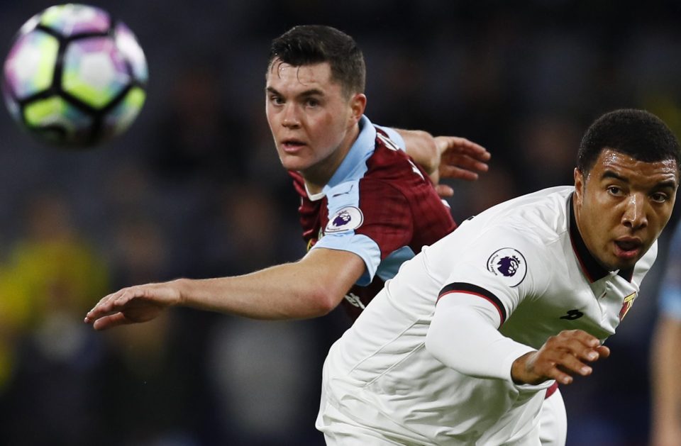  Turf war...Deeney in action with Michael Keane