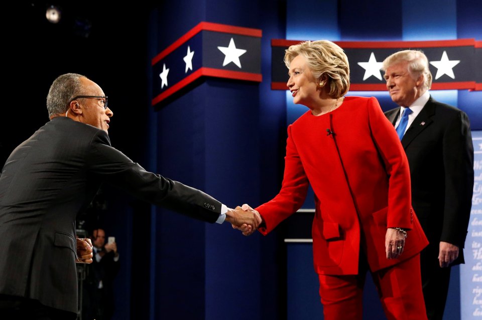  Hillary Clinton greets Lester Holt as she and Trump take the stage for their first debate