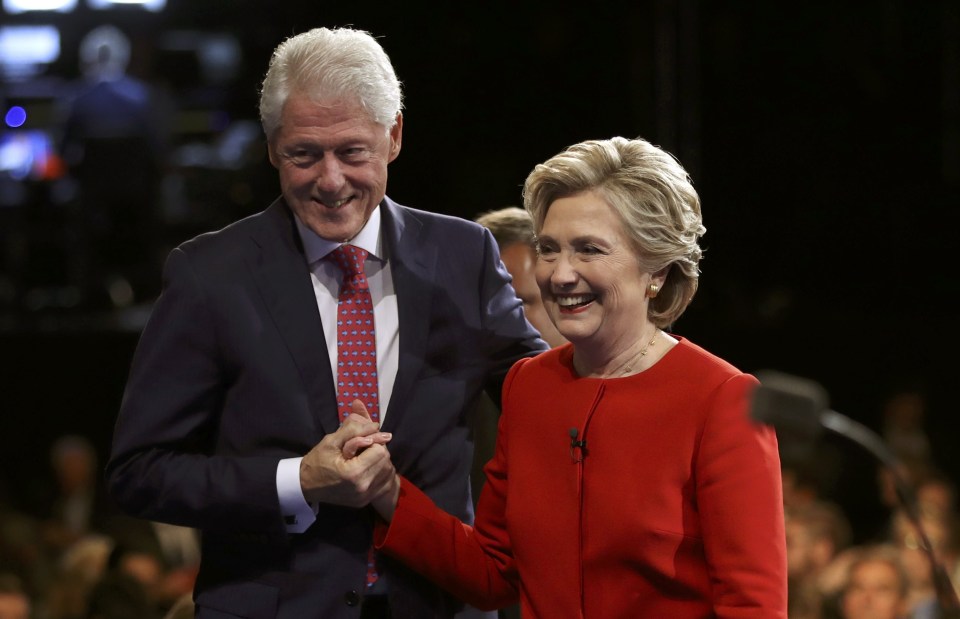  Democratic U.S. presidential nominee Hillary Clinton holds hands with her husband, former President Bill Clinton, as they leave the stage