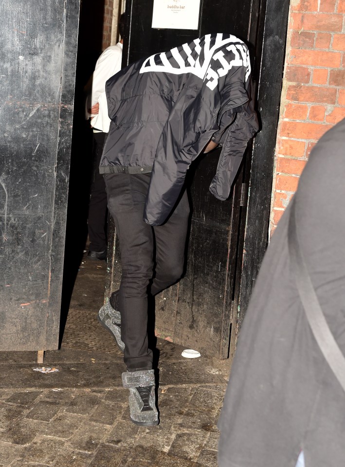  West Ham player covers his head as he leaves Signor Sassi restaurant after the teams meal together