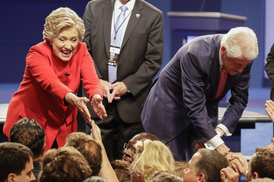  Hillary Clinton shakes hands with her husband Bill Clinton and audience members after the presidential debate