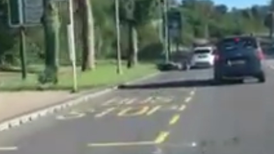  Scooter and its passengers lie on the road as the Fiesta leaves the scene of the incident in Coulsdon, Surrey