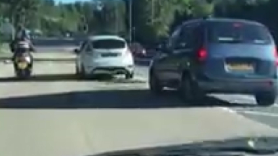  Fiesta can be seen side by side with scooter as they both make their way along the A23 in Surry