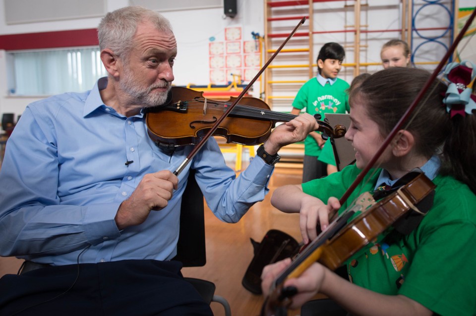 Jeremy Corbyn is given a violin lesson by 10-year-old Jessica Kelly