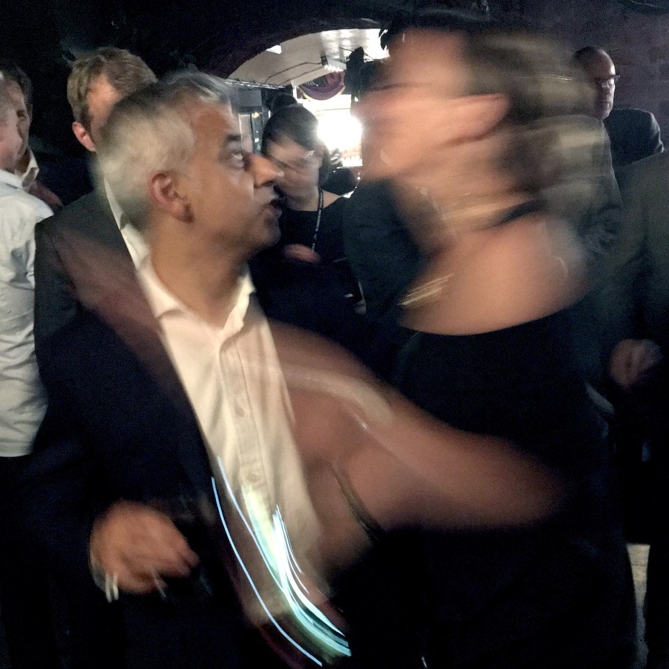  The shock is clearly evident on Sadiq Khan's face after the partygoer moved in for a kiss from the popular Labour politician