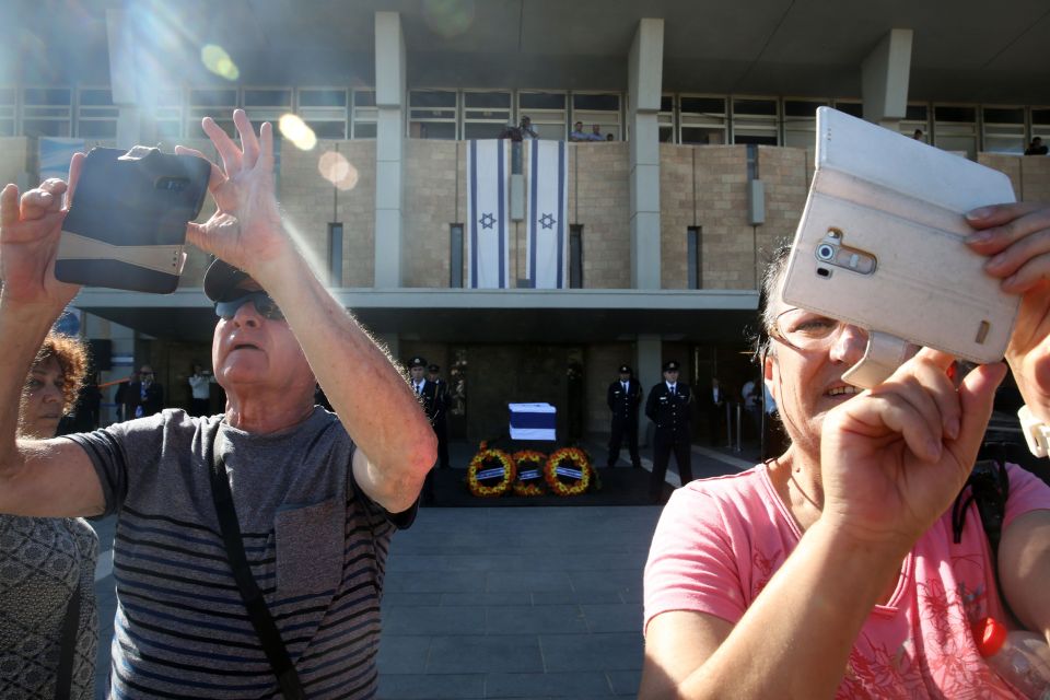 Some Israelis were seen snapping selfies in front of the coffin 