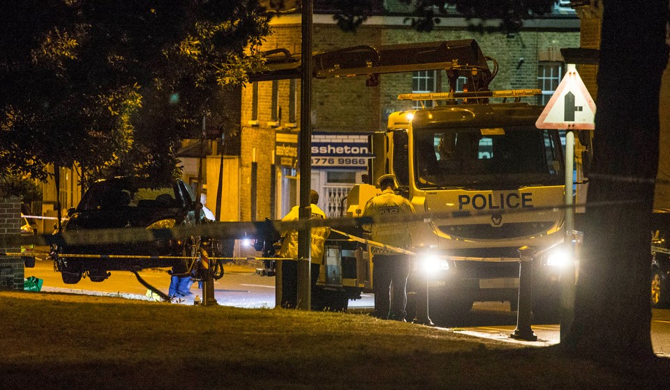  A police tow truck lifts a crashed Ford Fiesta car into the air in Lennard Road Penge. The car was reportedly being chased by police when it mounted the kerb killing a woman and a child.