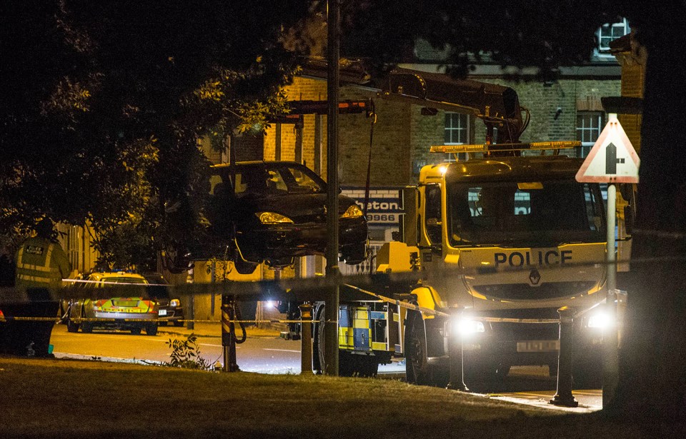  A police tow truck lifts a crashed Ford Fiesta car into the air in Lennard Road Penge. The car was reportedly being chased by police when it mounted the kerb killing a woman and a child.