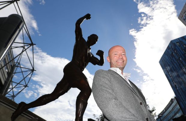 Alan Shearer poses with the statue recognising his status as a Toon strike legend