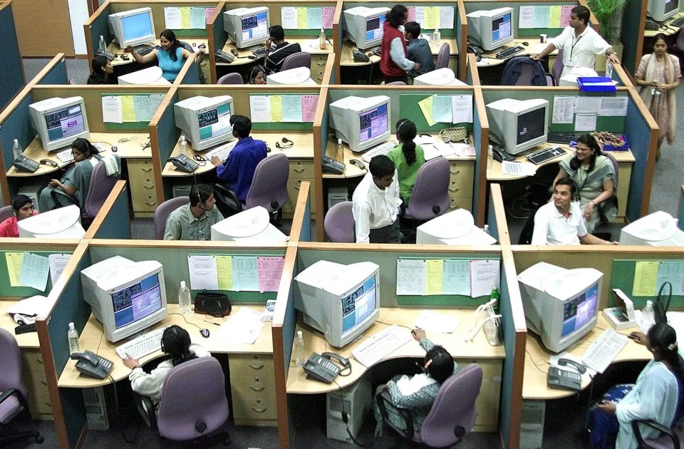 Indian employees work at a call centre in the southern Indian city of Bangalore in this June 26, 2003 file photo. As global giants move business functions to cheaper locations including India and the Philippines, companies are educating and training their work force in the different types and manners of their overseas customers. Picture taken June 26, 2003. TO ACCOMPANY FEATURE TECH-CALLCENTRES REUTERS/Jagadeesh NV/Files