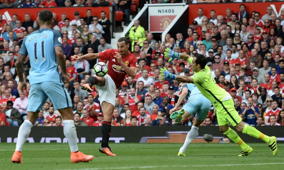 Manchester United's Swedish striker Zlatan Ibrahimovic (2nd L) shoots past Manchester City's Chilean goalkeeper Claudio Bravo to score their first goal during the English Premier League football match between Manchester United and Manchester City at Old Trafford in Manchester, north west England, on September 10, 2016. / AFP / Oli SCARFF / RESTRICTED TO EDITORIAL USE. No use with unauthorized audio, video, data, fixture lists, club/league logos or 'live' services. Online in-match use limited to 75 images, no video emulation. No use in betting, games or single club/league/player publications. / (Photo credit should read OLI SCARFF/AFP/Getty Images)