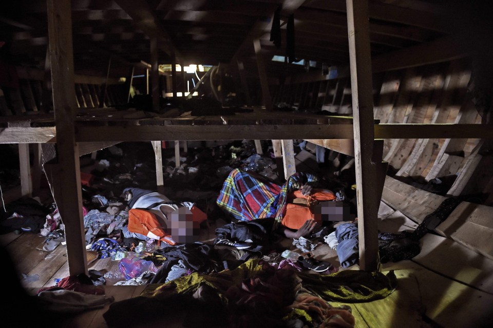 Dead bodies lie on the bottom level of a third-level wooden vessel