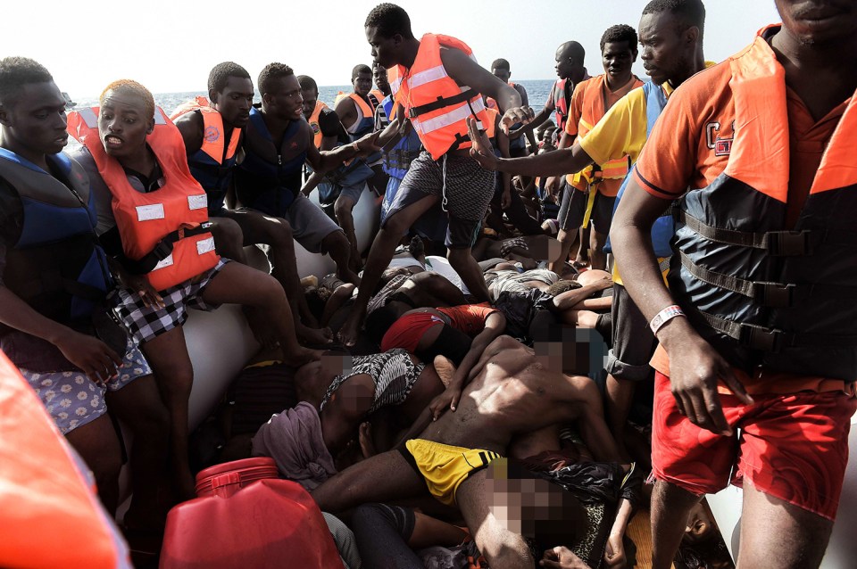  Graphic content / Dead bodies lie on a boat after Europe-bound migrants were rescued by members of Proactiva Open Arms NGO in the Mediterranean Sea, some 12 nautical miles north of Libya, on October 4, 2016. Twenty-eight Europe-bound migrants were found dead on a day of frantic rescues off Libya, including at least 22 in an overloaded wooden boat, an AFP photographer and the Italian coastguard said. / AFP PHOTO / ARIS MESSINISARIS MESSINIS/AFP/Getty Images