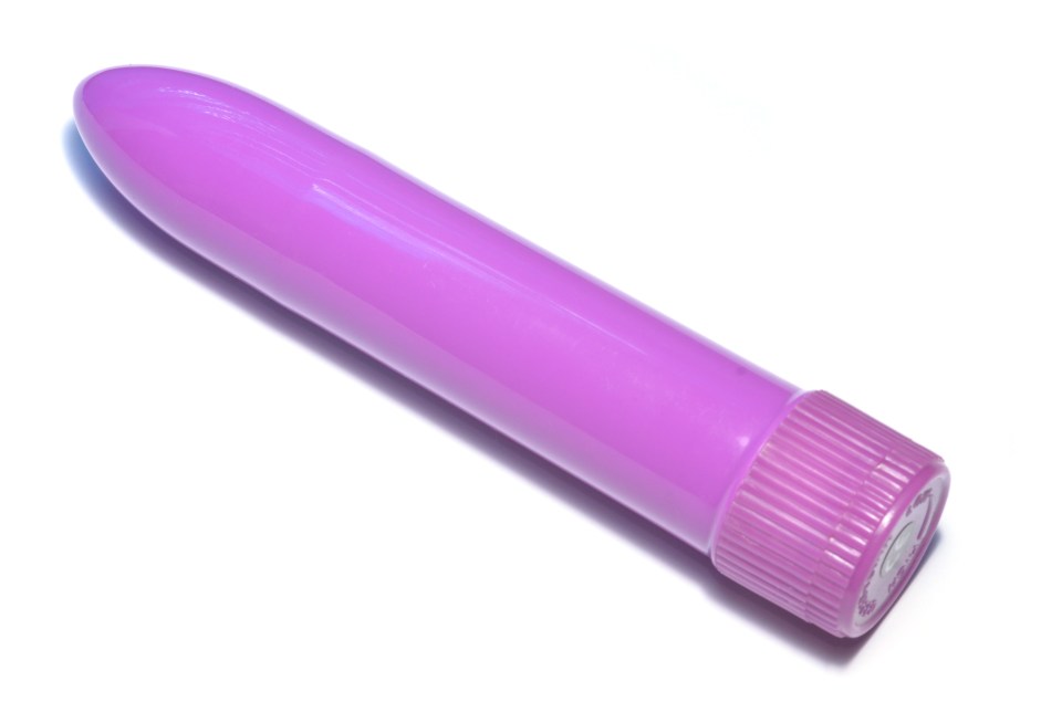 Purple vibrator on white background