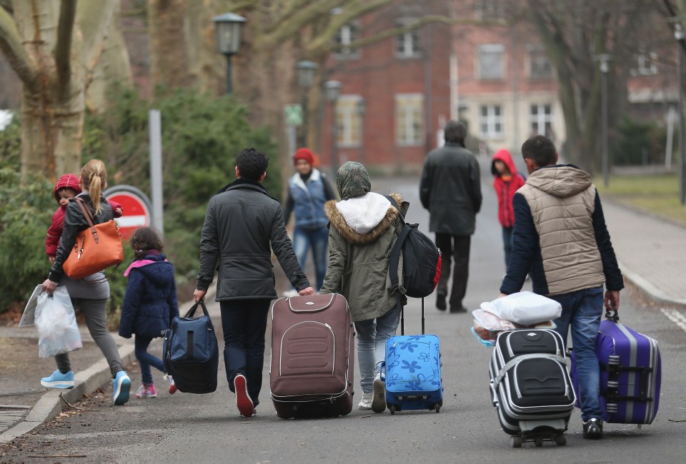 BERLIN, GERMANY - MARCH 11: People pulling suitcases arrive at the Central Registration Office for Asylum Seekers (Zentrale Aufnahmestelle fuer Fluechtlinge, or ZAA) of the State Office for Health and Social Services (Landesamt fuer Gesundheit und Soziales, or LAGeSo), which is the registration office for refugees and migrants arriving in Berlin who are seeking asylum in Germany, on March 11, 2015 in Berlin, Germany. Germany, which registered over 200,000 refugees in 2014, is expecting even more in 2015 and many cities and towns are reeling under the burden of having to accommodate them. The main countries of origin of the refugees include Syria, Serbia, Eritrea, Afghanistan, Iraq, Kosovo and Albania. (Photo by Sean Gallup/Getty Images)