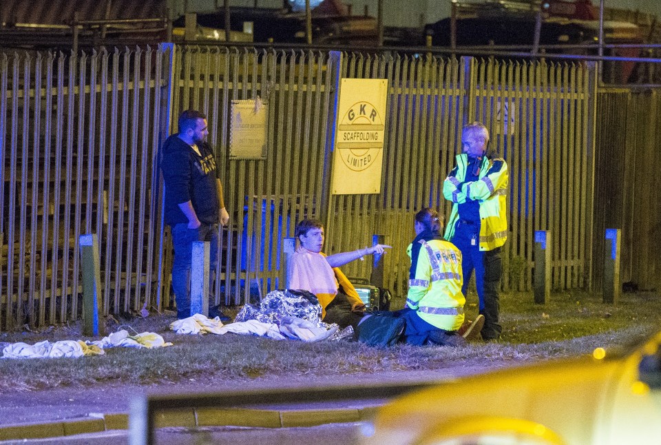  Police talk to people at the scene