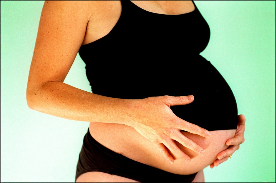 Pregnancy woman with hand on her pregnant belly