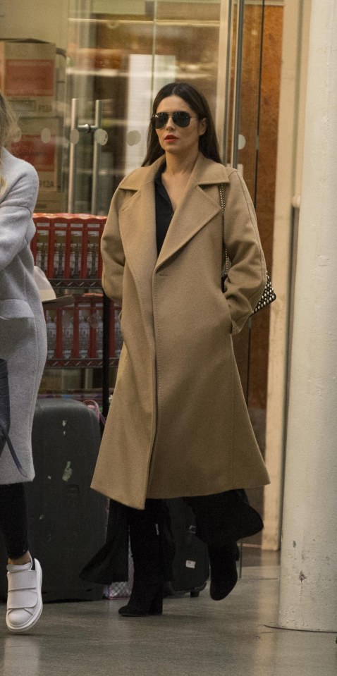 Cheryl kept her figure under wraps in this big coat in London last week