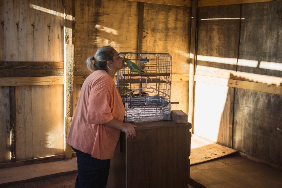  Resident Larriaune Cosmo kisses her pet bird Polly. She suffers from bipolar disorder, she is unable to afford her much needed medication, and her state disability income does not cover all of her medicinal needs