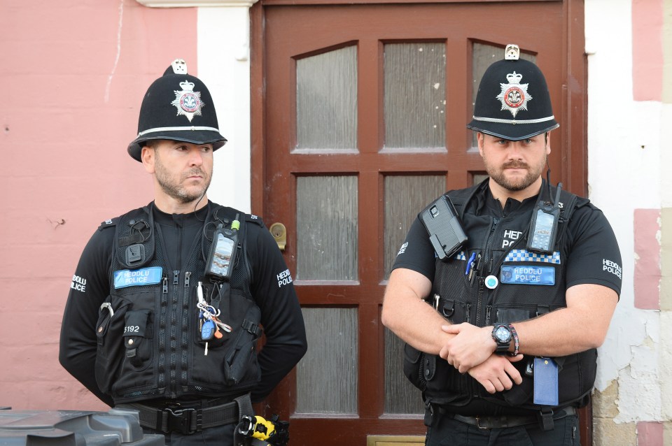  Police stood guard outside the front door during a search of the family's terraced house