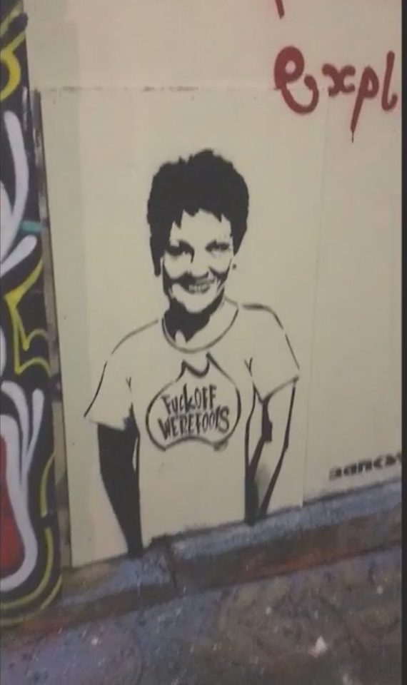 The man looked to be painting a mural on the wall of the alley - an apparent picture of anti-immigration politician Pauline Hanson