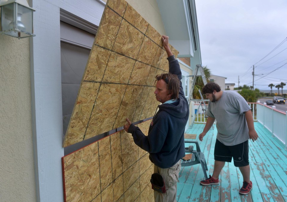  A man boards up his home in Tybee Island, Georgia, where a voluntary evacuation has been ordered