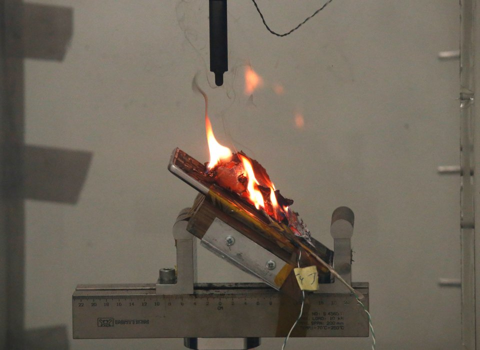 The Note 7 is seen smouldering on a test bench