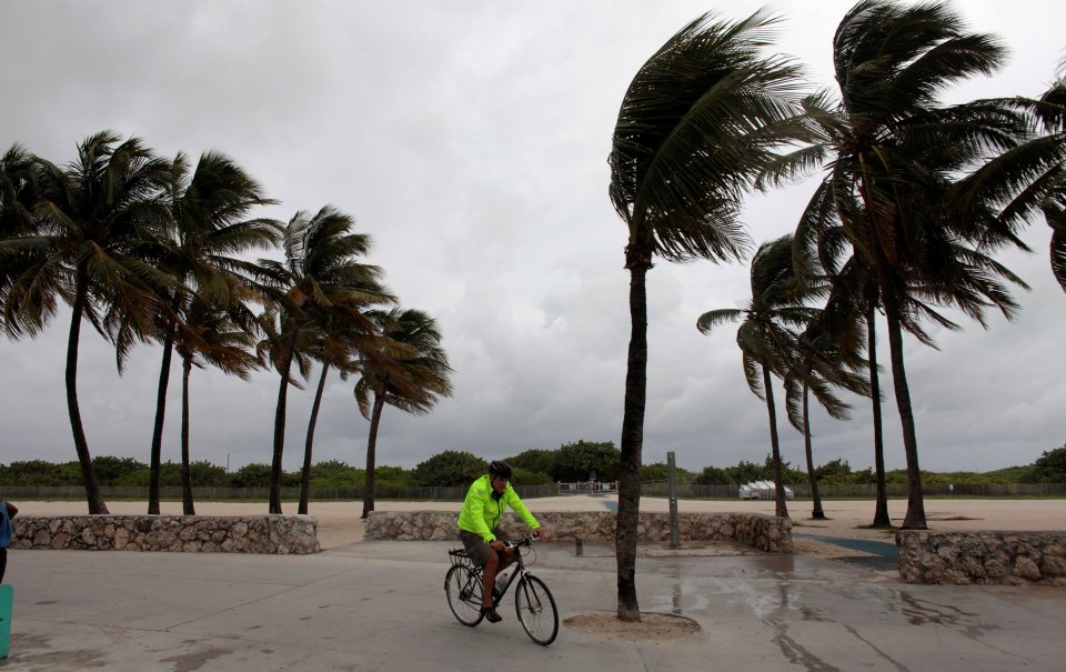 A man rides his bike through the strong winds as the state prepares for the hurricane