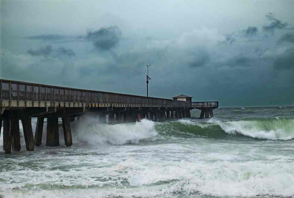 Waves whipped up by the storm pound the Pompano Beach fishing pier 