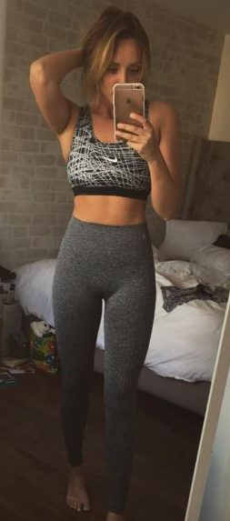 Gym bunny Charlotte poses in a grey Nike sports bra and running pants