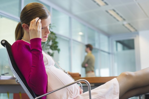 Pregnant woman sitting in the office