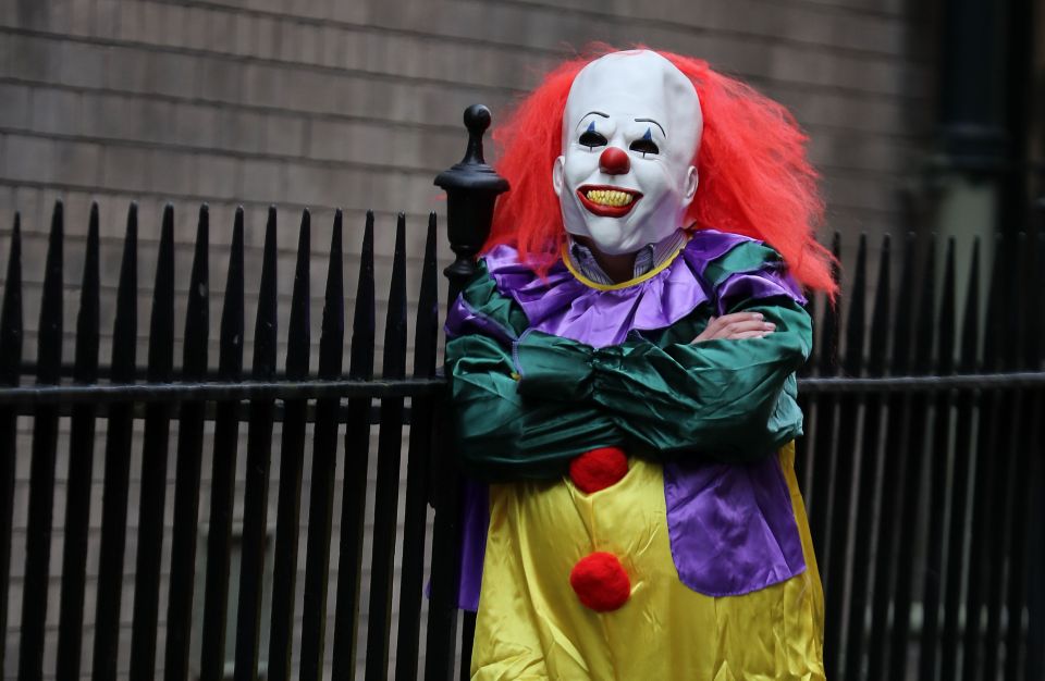  A person wearing a clown costume in a street in Liverpool, to illustrate the "killer clown" craze