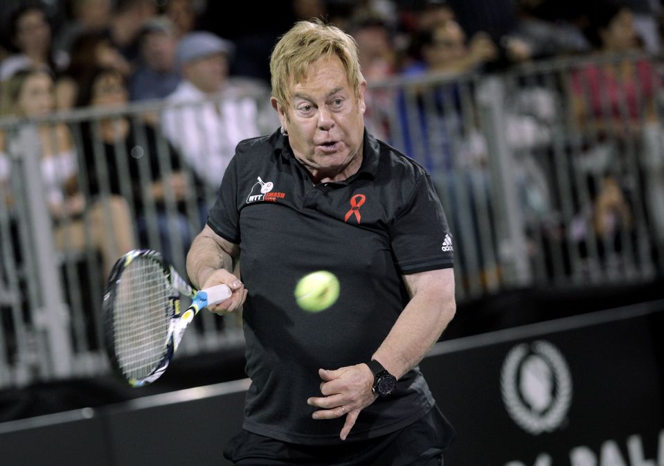  I'm a racket man... Elton John shows off his tennis skills on court