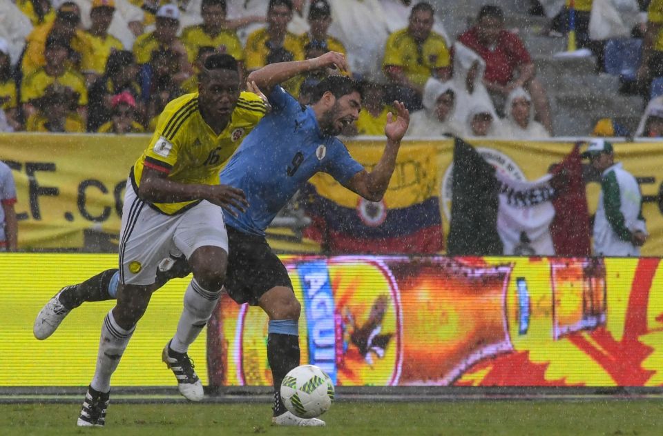 Uruguay's Luis Suarez (R) and Colombia's defender Yerry Mina (L) vie for the ball during their Russia 2018 FIFA World Cup qualifier football match in Barranquilla, Colombia, on October 11, 2016. / AFP PHOTO / Luis AcostaLUIS ACOSTA/AFP/Getty Images