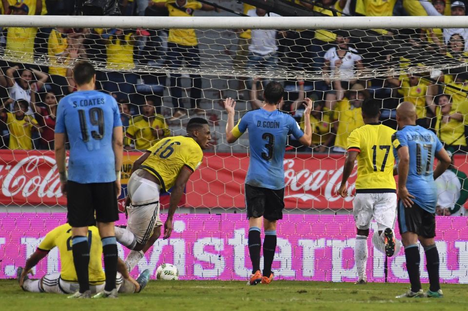 Colombia's defender Yerry Mina (C) scores against Uruguay during their Russia 2018 World Cup qualifier football match in Barranquilla, Colombia, on October 11, 2016. / AFP PHOTO / Luis AcostaLUIS ACOSTA/AFP/Getty Images