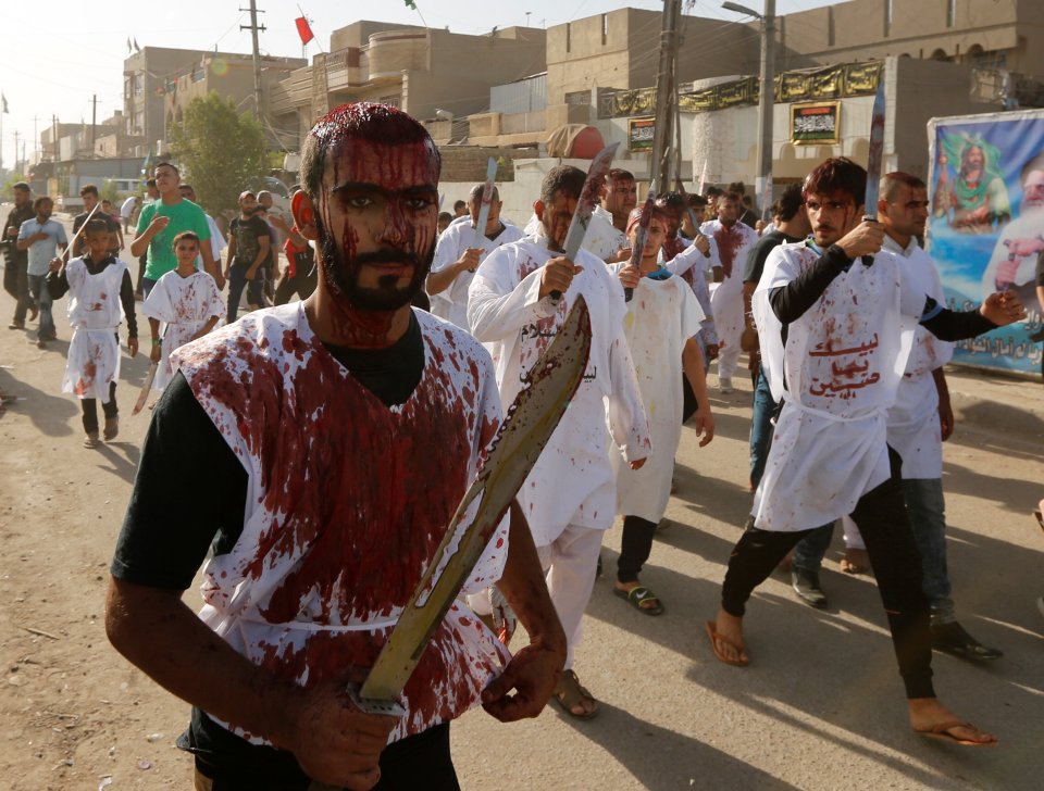  Iraq Shi'ite Muslim men bleed as they gash their foreheads with swords and beat themselves