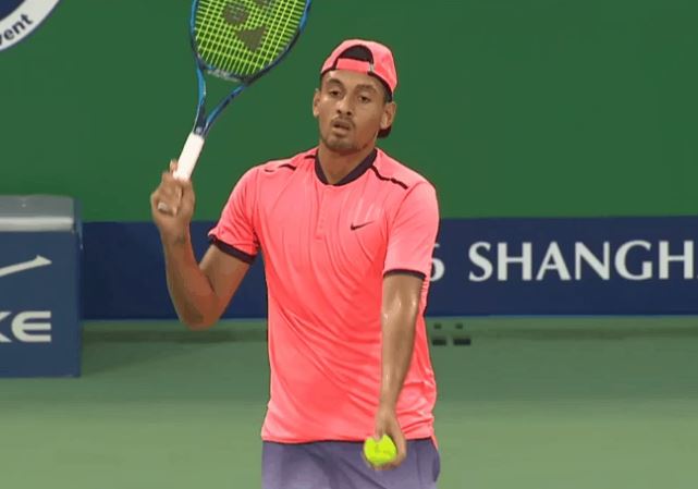  Nick Kyrgios pats a serve over the net in his disgraceful defeat