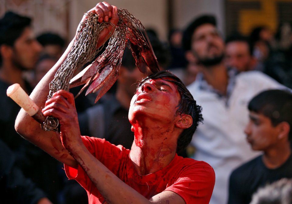  A Kashmiri Shi'ite Muslim mourner pictured whipping himself with blades