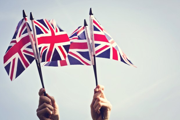 Hands waving Union Jack flags.