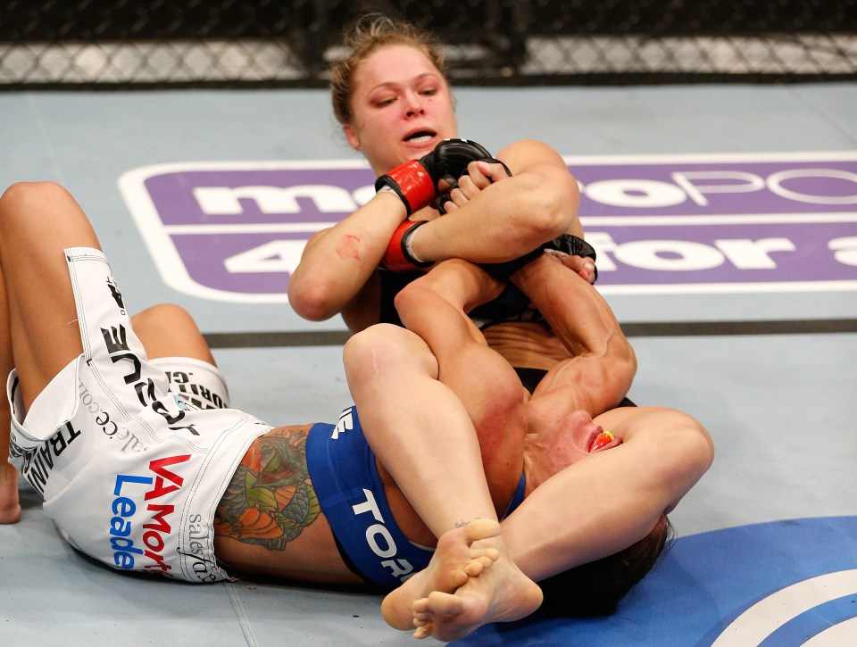  Locking up the finisher: Ronda Rousey applies her armbar submission to defeat Liz Carmouche on her UFC debut at UFC 157