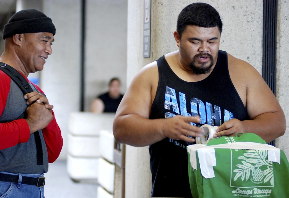 Mua Migi, left, doesn't like the airline's new policy of assigning seats at the airport 