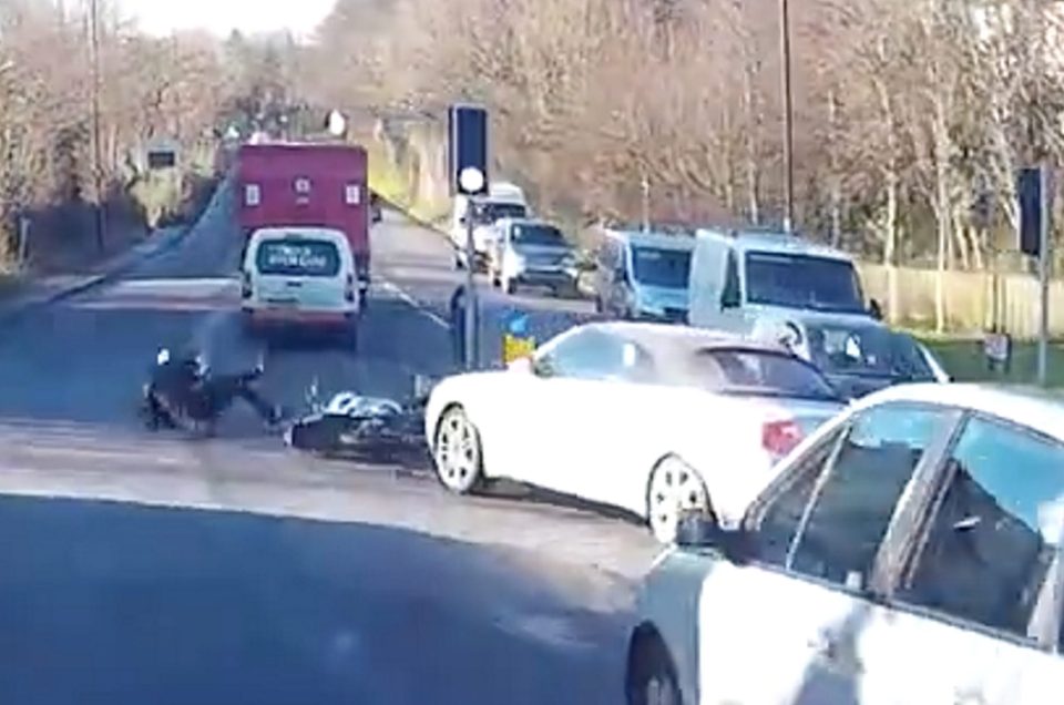  The motorcyclist can be seen falling to the ground after being hit by the Audi