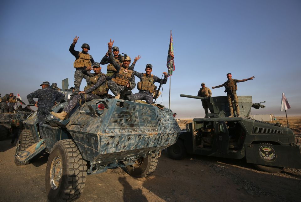 Iraqi forces flash the 'V' sign for victory in al-Shourah