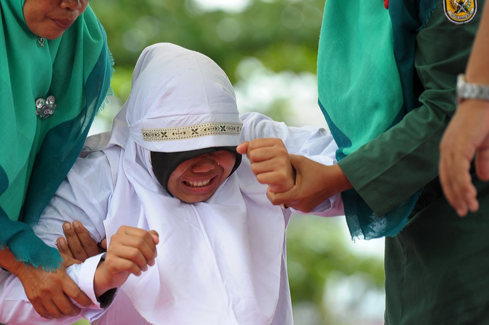 A Muslim girl gets taken to be caned 23