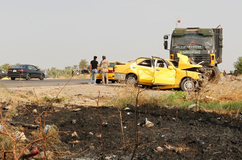 Iraqi troops gather at the site of an ISIS car bomb 