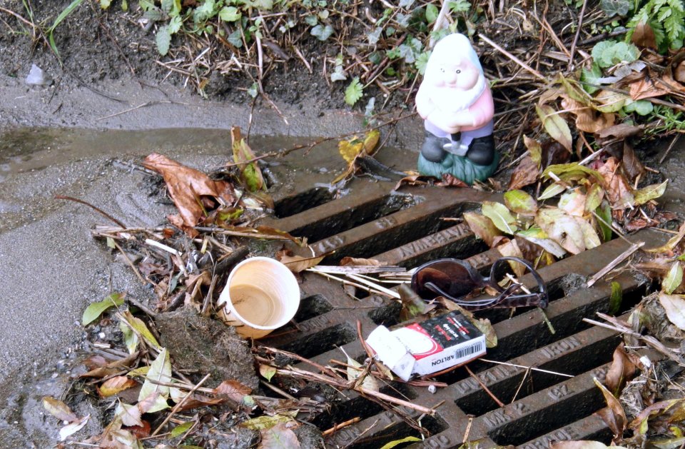  Trash flood . . . cup, fag pack, even sun shades block this drain