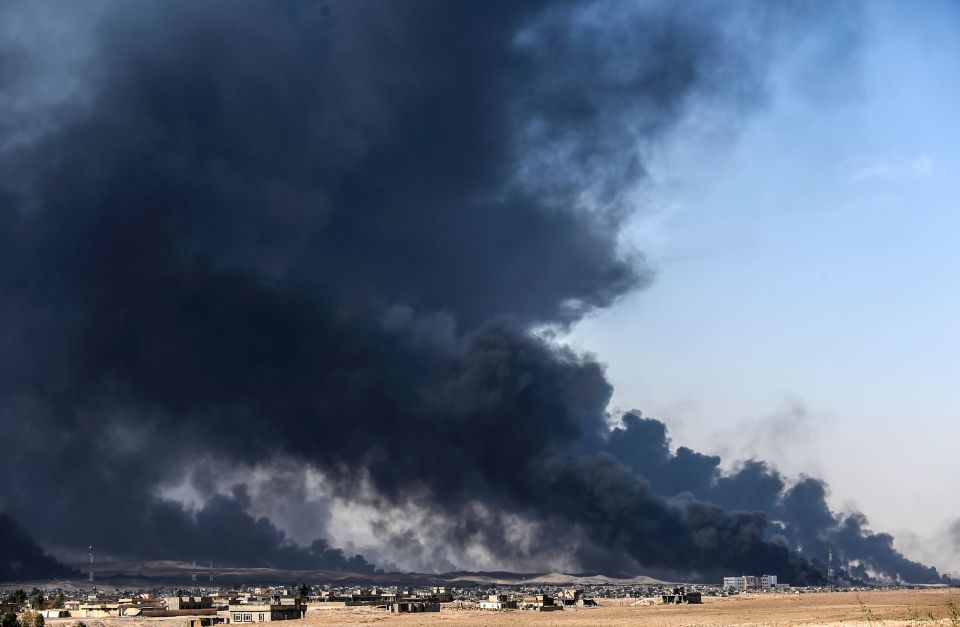 Plumes of smoke rise over the villages outside Mosul after they were set ablaze by ISIS jihadis