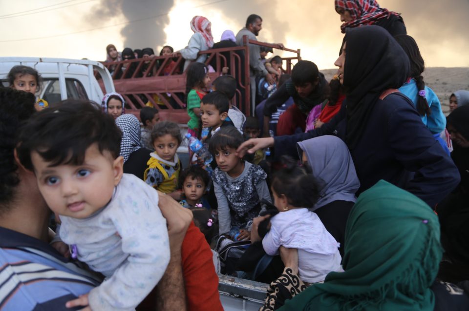 Iraqi internally displaced civilians are seen as they have arrived at Al Qayyarah town, secured by Iraqi Army, in Mosul