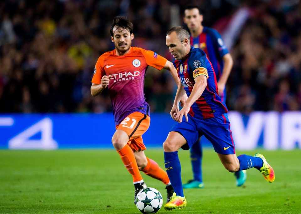 BARCELONA, SPAIN - OCTOBER 19: Andres Iniesta (R) of FC Barcelona runs with the ball next to David Silva of Manchester City FC during the UEFA Champions League group C match between FC Barcelona and Manchester City FC at Camp Nou on October 19, 2016 in Barcelona, Spain. (Photo by Alex Caparros/Getty Images)