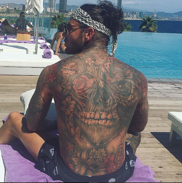  Now THIS is a solid collection of tattoos. The terrifying skull on the back of this TOWIE hunk's back would be enough to scare anyone away in the bedroom